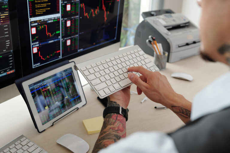 Hands of trader hurrying to buy new company stocks after its initial public offering