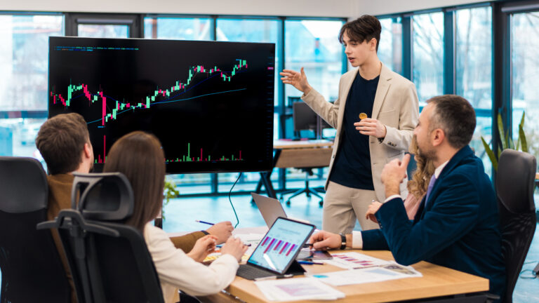 Young worker leading business meeting about cryptocurrencies in an office