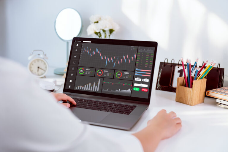 Stock exchange market concept businesswoman trader looking computer with graphs analysis candle line on table in office diagrams on screen